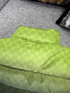 Lime green padded jacket with allover GG logo pattern and stitched hem