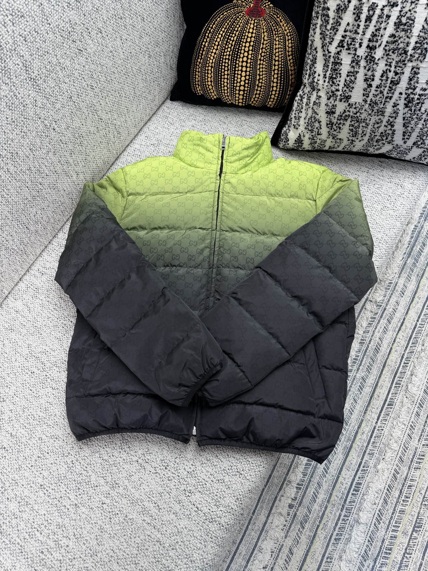 Long padded puffer jacket, black with quilted panels and front zipper