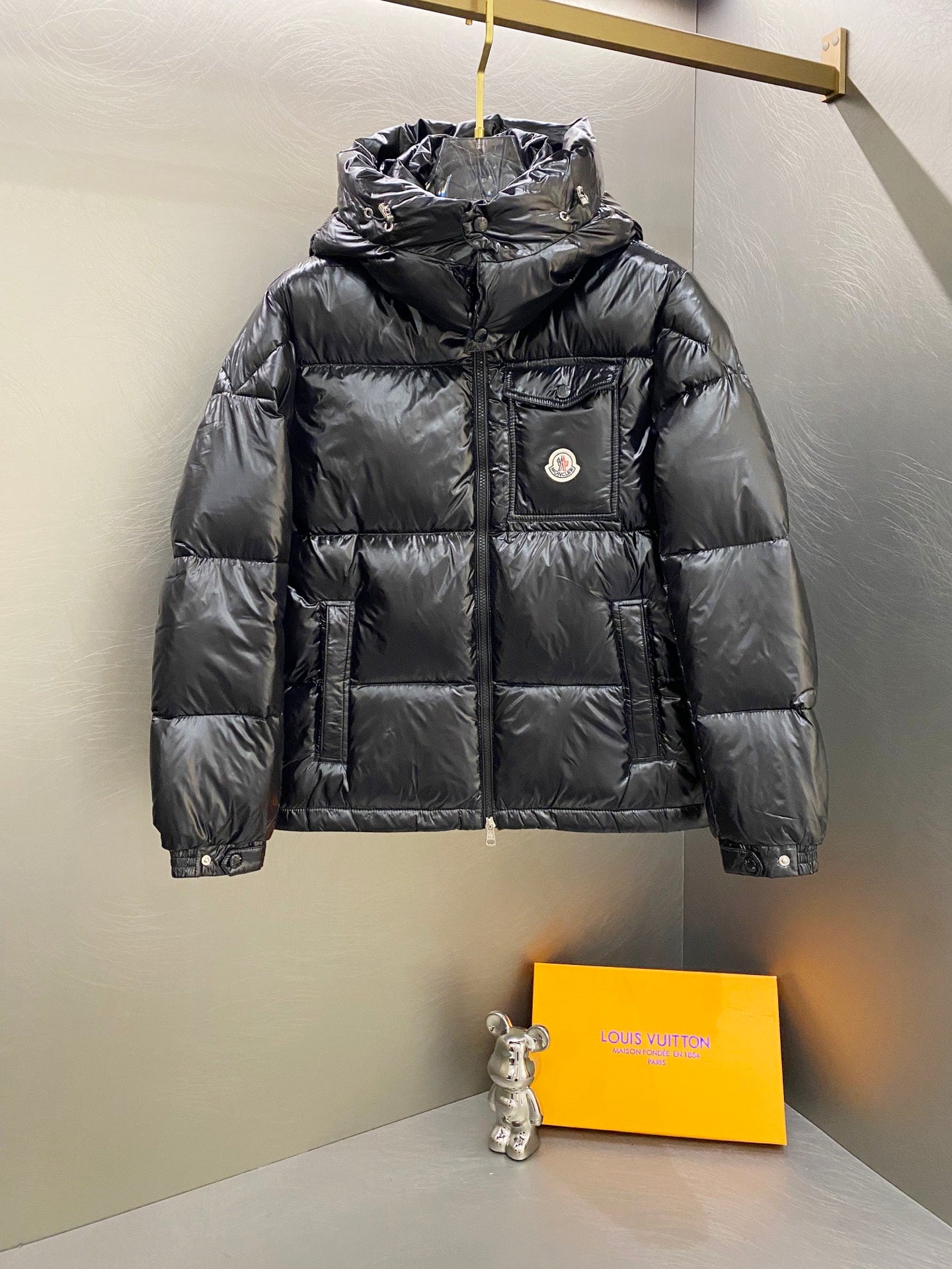 Moncler long padded jacket front with hood, dark quilted panels and chest logo patch