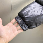 Moncler long padded jacket cuff detail on dark sleeve, snap buttons and label