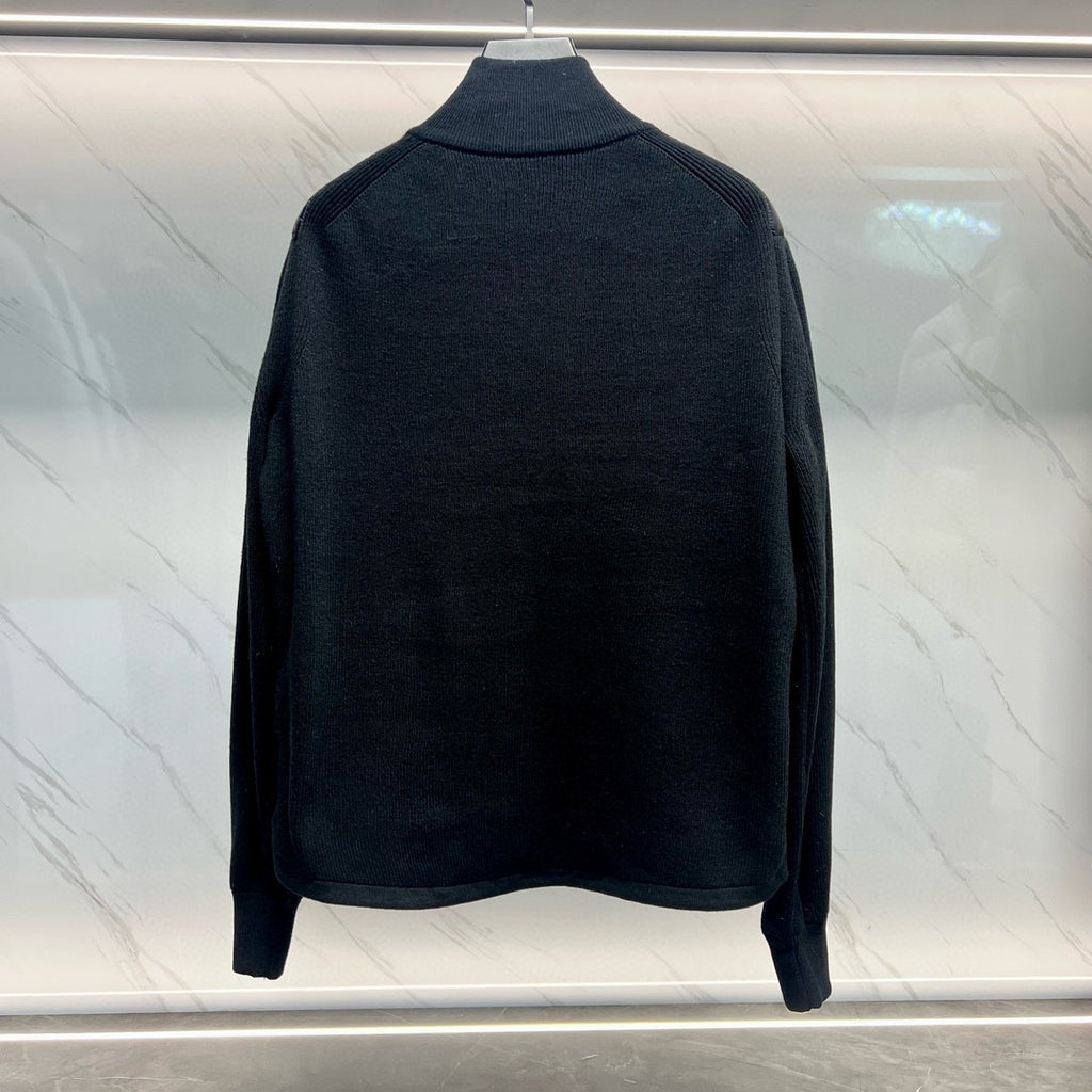Back view of long quilted jacket with dark knit collar and full-length sleeves