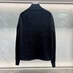 Back view of long quilted jacket with dark knit collar and full-length sleeves