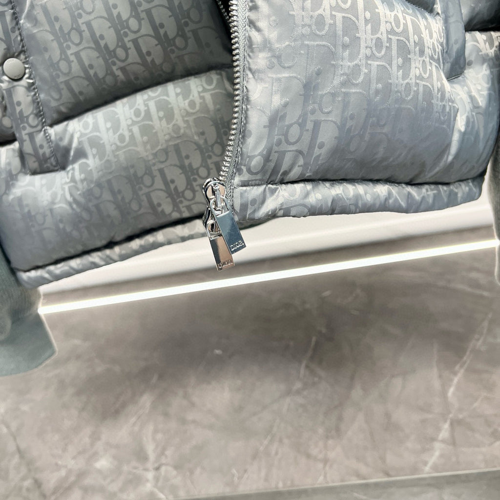 Dior light gray puffer jacket zipper and metal pull near the hem