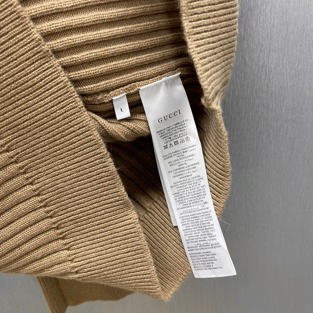 Beige ribbed knit cardigan with inner care label and size tag