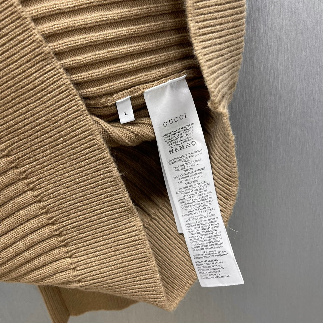 Beige ribbed knit cardigan with inner care label and size tag