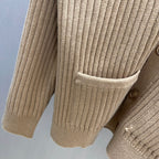 Beige ribbed knit cardigan with patch pocket and button
