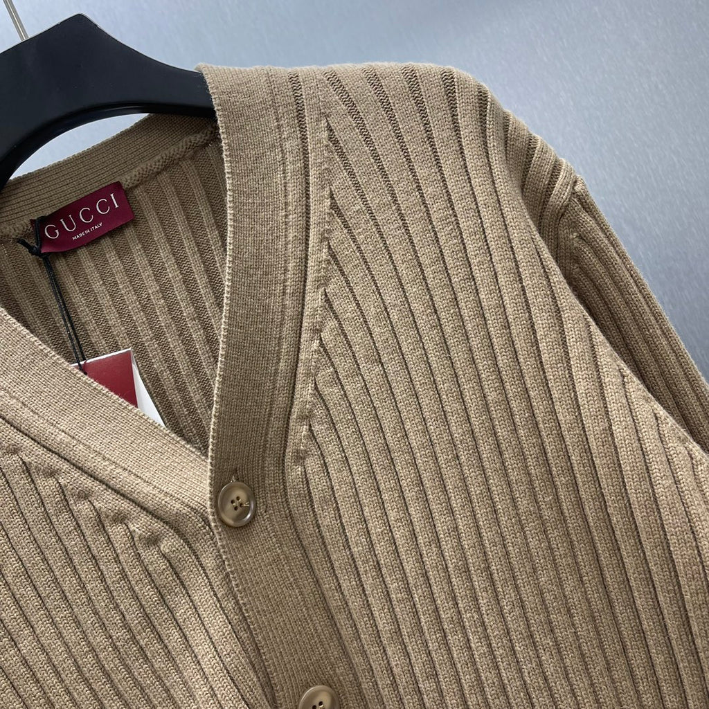 Beige ribbed knit cardigan with button detail at neckline