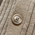 Beige ribbed knit cardigan close-up of round button