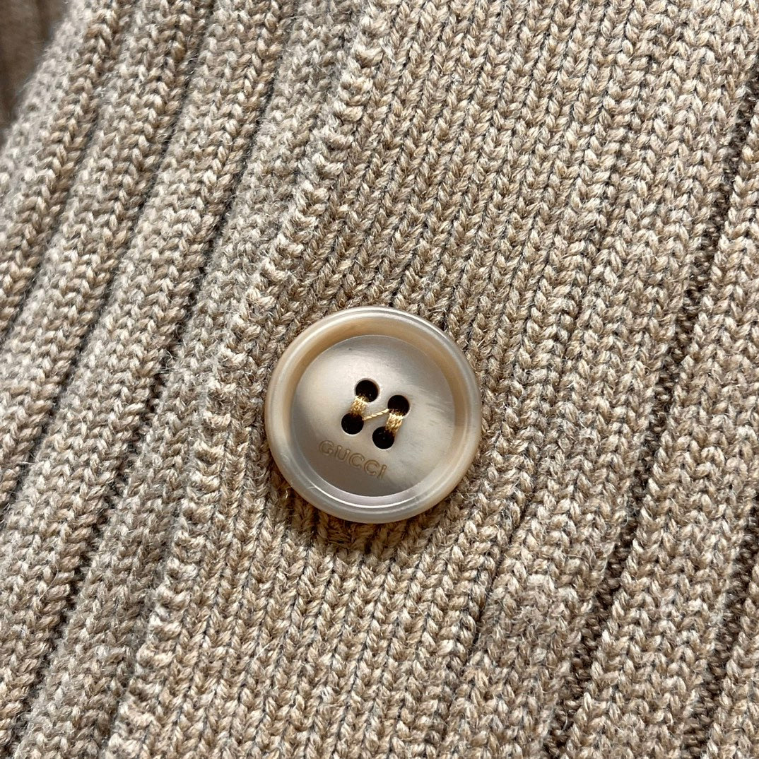 Beige ribbed knit cardigan close-up of round button