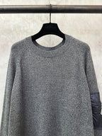 Gray heather knit sweater with ribbed crew neckline and long sleeves