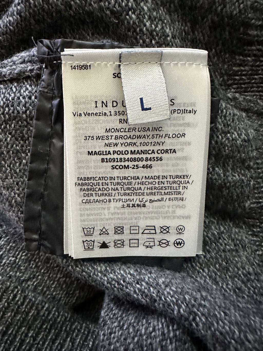 Clothing label inside heather knit sweater with size and care information