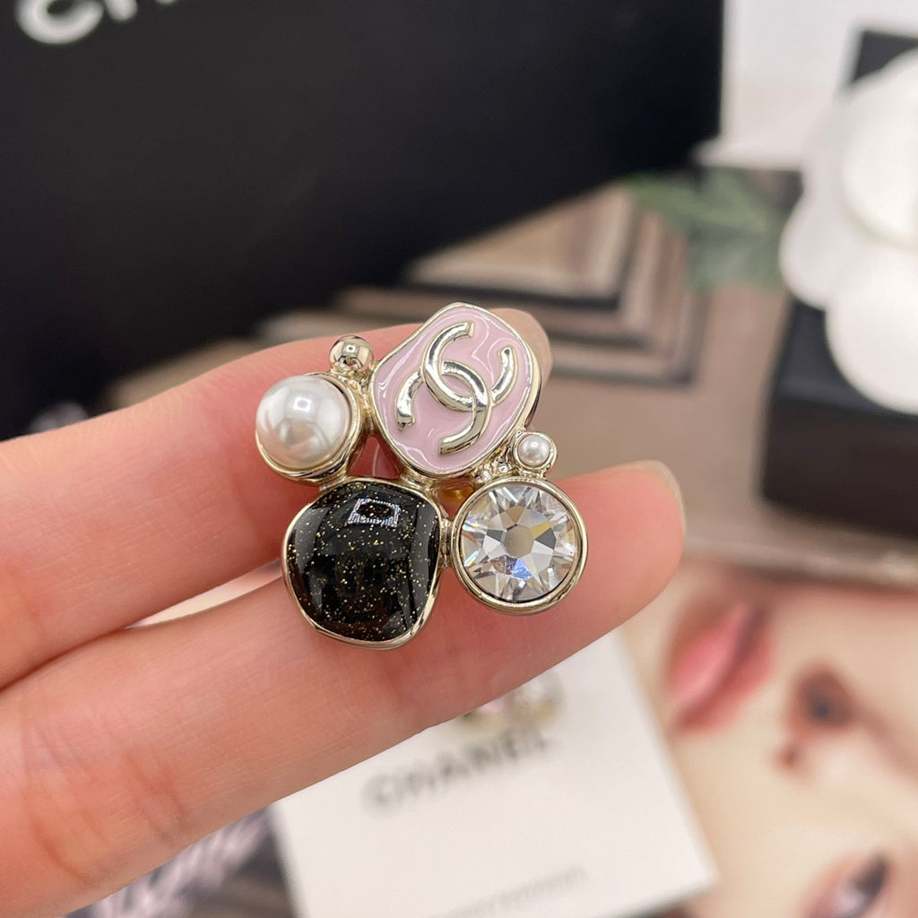 Chanel-style charm earrings close-up, pink enamel and faux pearl with clear rhinestone