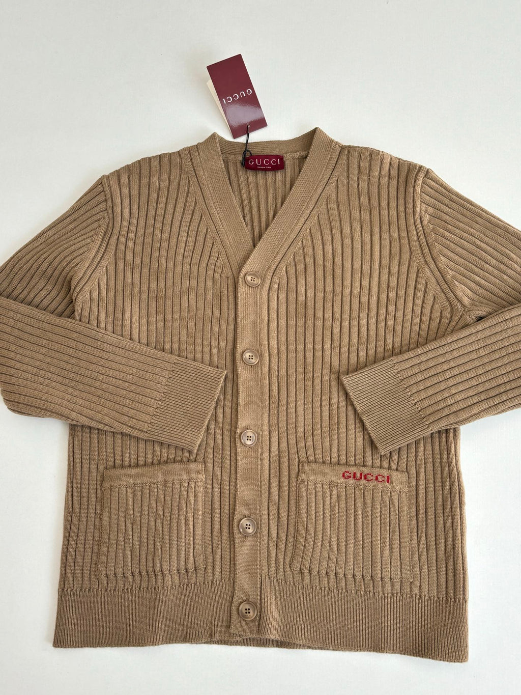 Tan ribbed knit cardigan with V-neck, button front, and Gucci logo patch