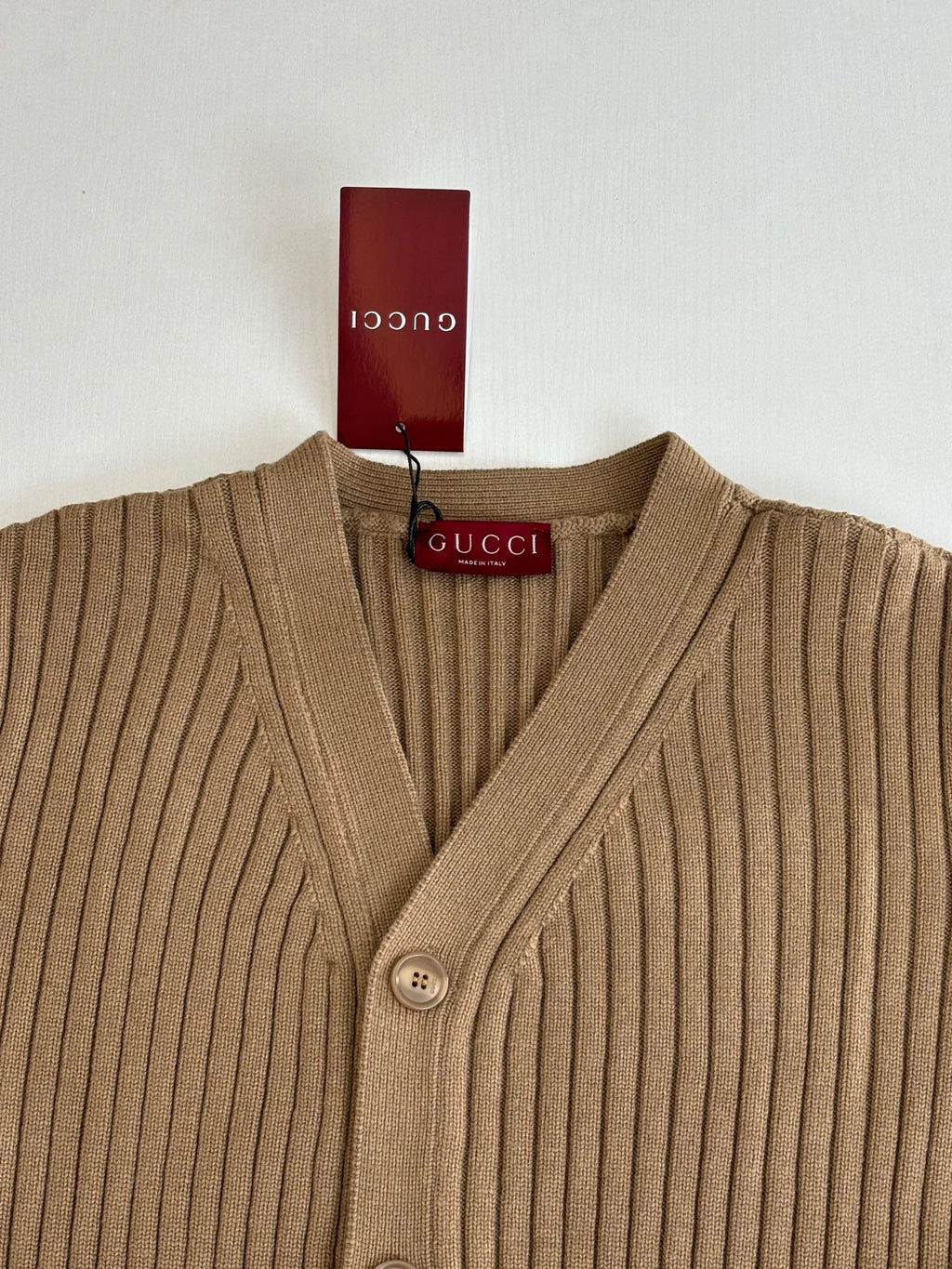 Tan ribbed knit V-neck cardigan with button placket and Gucci logo tag