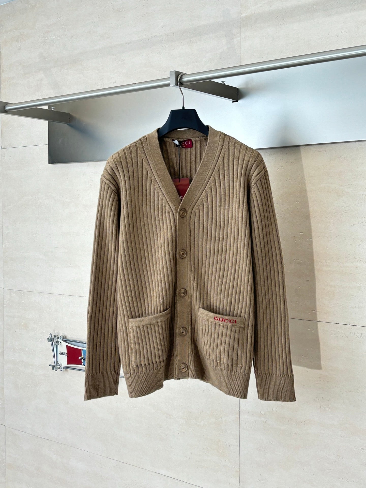 Tan ribbed knit cardigan with button front and patch pocket detail