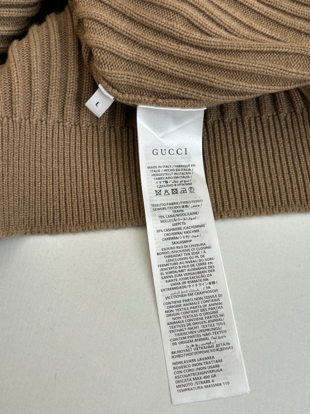 Tan ribbed knit cardigan care label tag on the inner hem