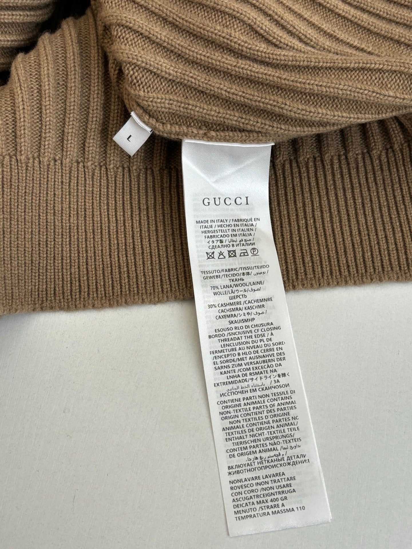 Tan ribbed knit cardigan care label tag on the inner hem