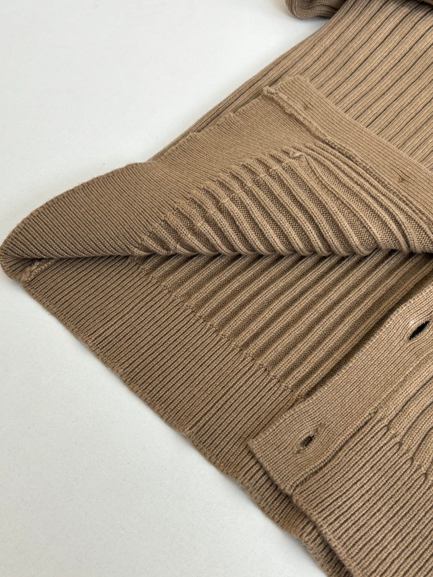 Tan ribbed knit cardigan with folded shoulder and ribbed sleeve cuff detail
