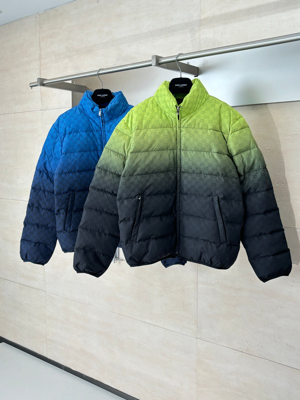 Puffer jackets on hangers: lime green and blue with full-zip fronts