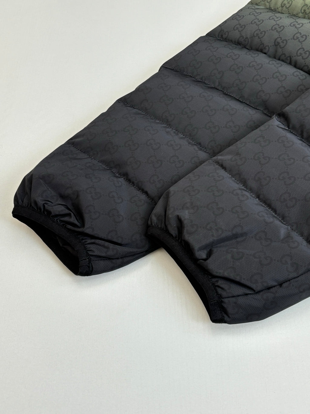 Gucci long puffer jacket in dark tone, quilted sections and zip front