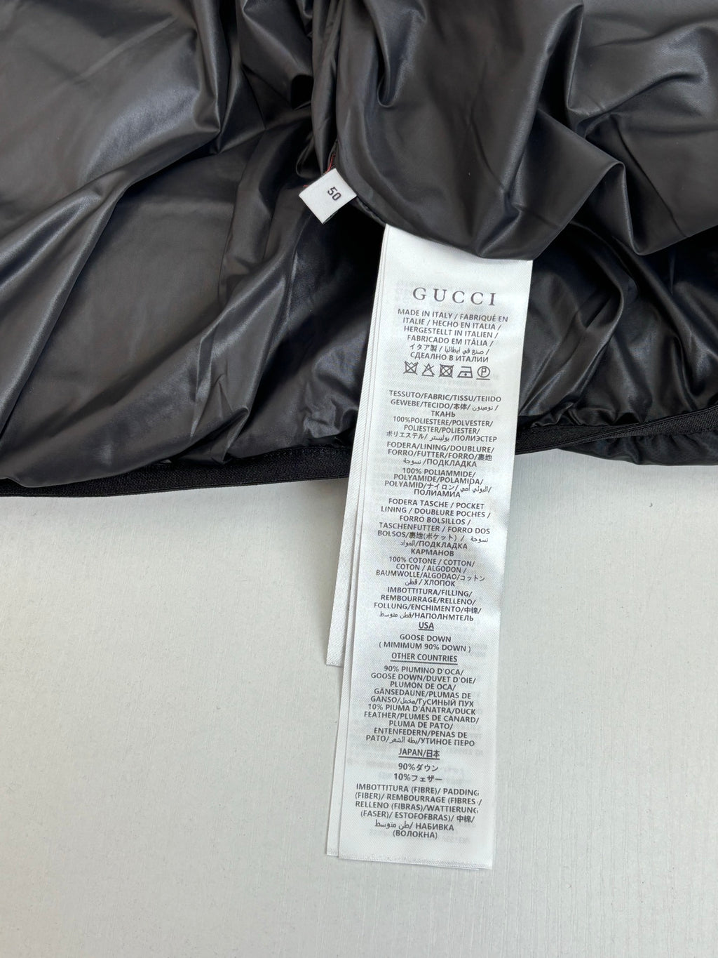 Gucci long puffer jacket with white care label and brand tag