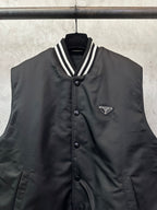 Sleeveless dark bomber vest with button placket and Prada triangular logo