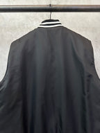 Sleeveless dark bomber vest back view with striped collar detail