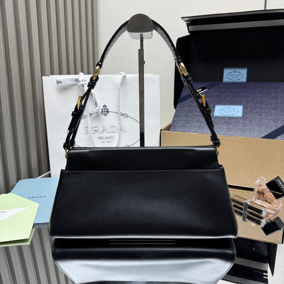 Prada black leather handbag with top handles and gold-tone chain strap hardware.