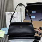 Prada black leather shoulder bag with top handle and gold-tone hardware.