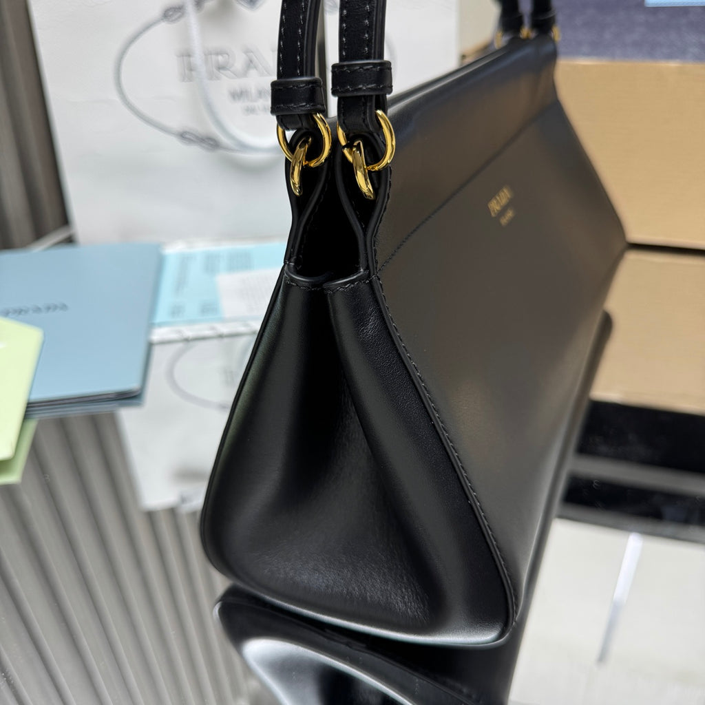 Prada black leather handbag with double top handles and gold-tone hardware.