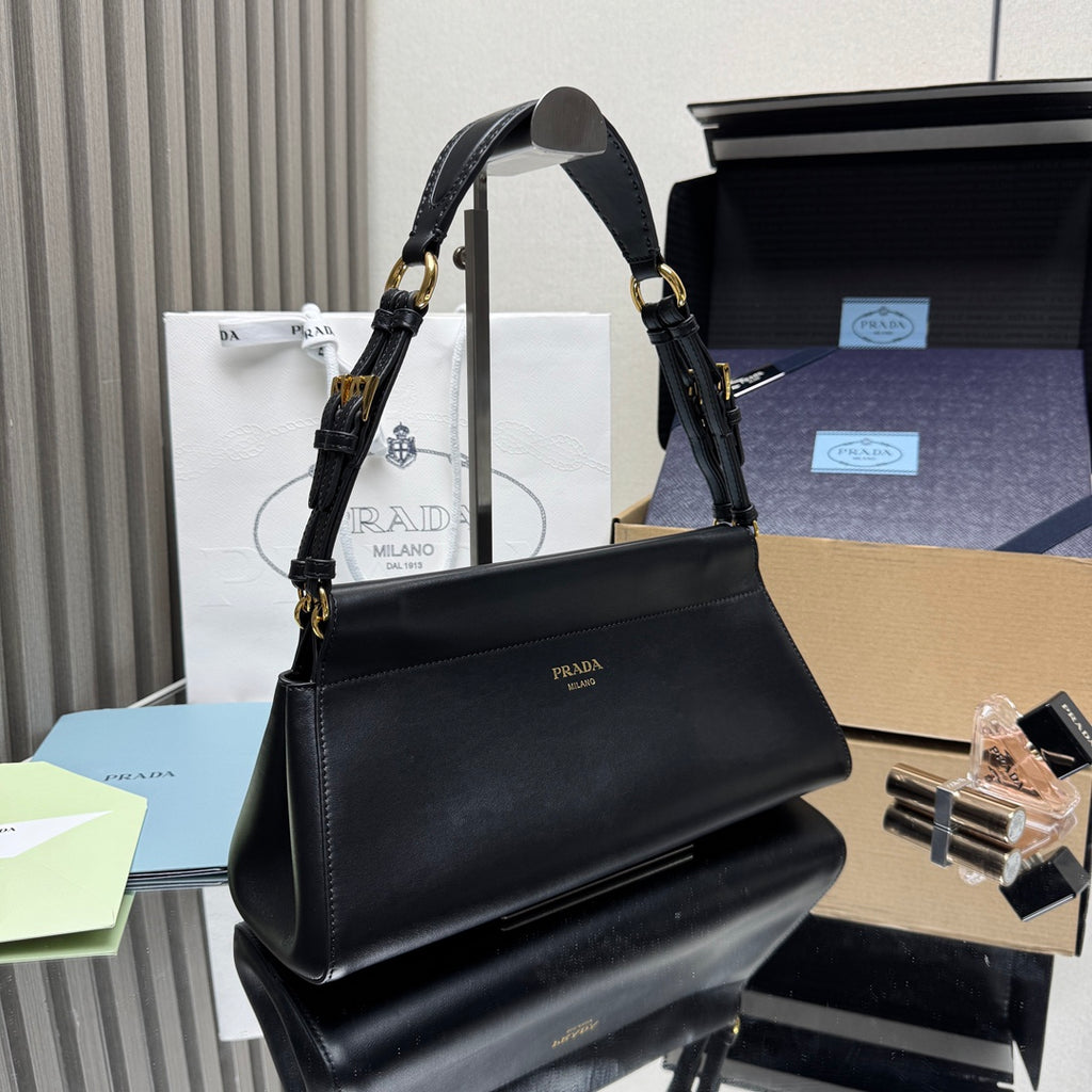 Prada black leather handbag with structured shape and gold-tone chain straps.