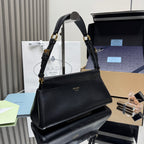 Prada black leather handbag with structured shape and gold-tone chain straps.