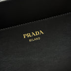 Prada Milano leather logo patch on black bag with contrast topstitching.