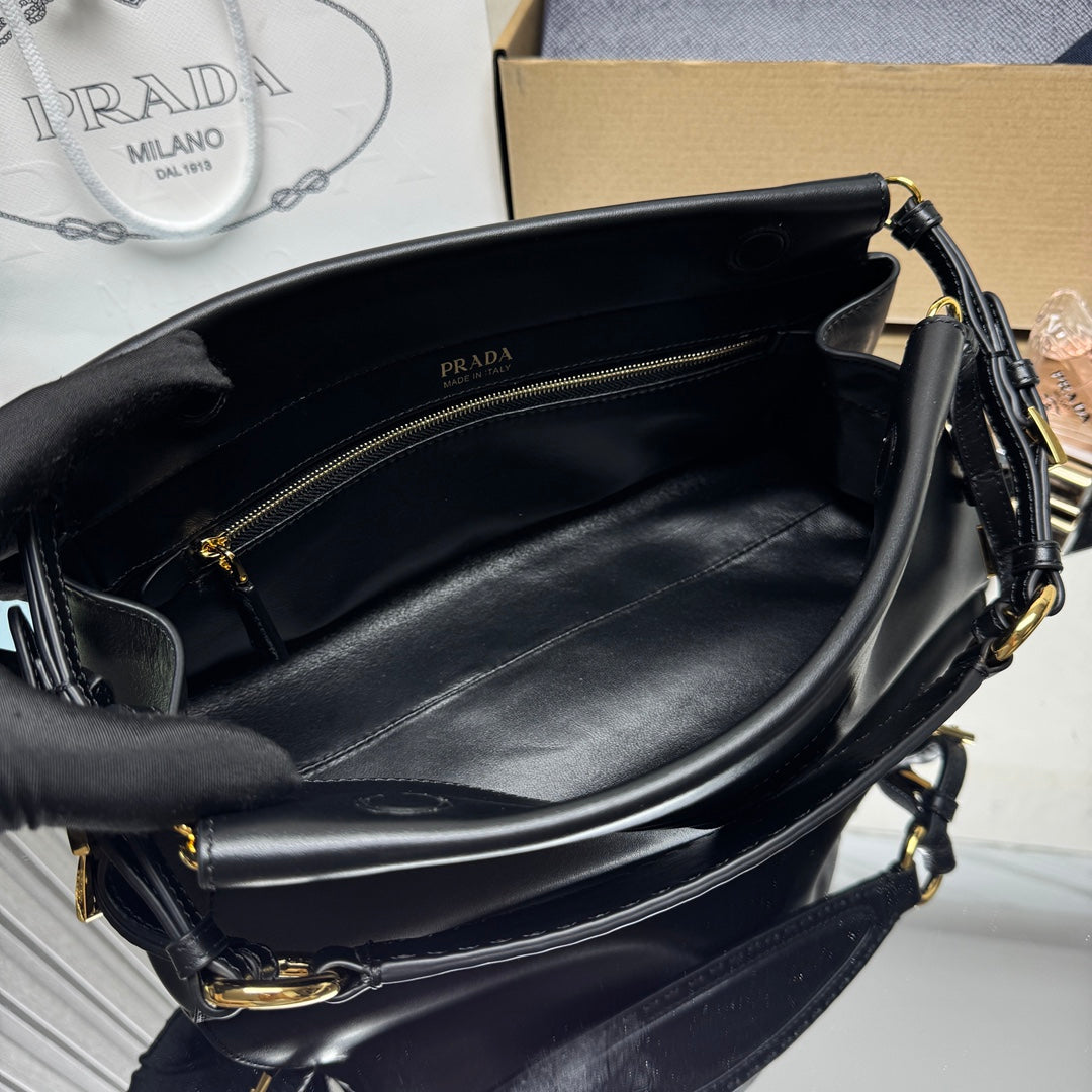 Prada black leather handbag interior with zip pocket and gold-tone zipper.