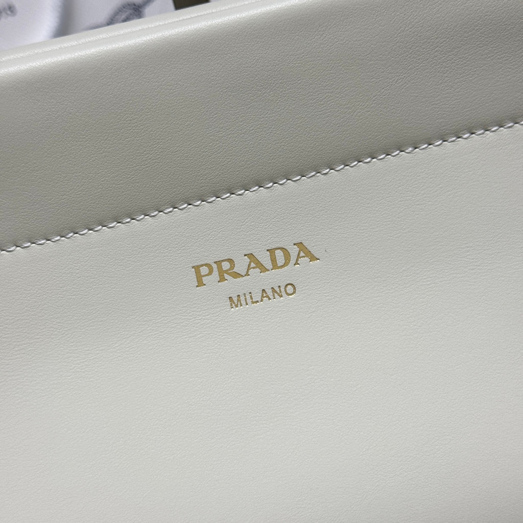 Prada logo on white leather handbag front panel with decorative stitching