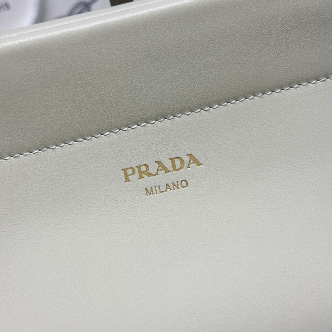Prada logo on white leather handbag front panel with decorative stitching