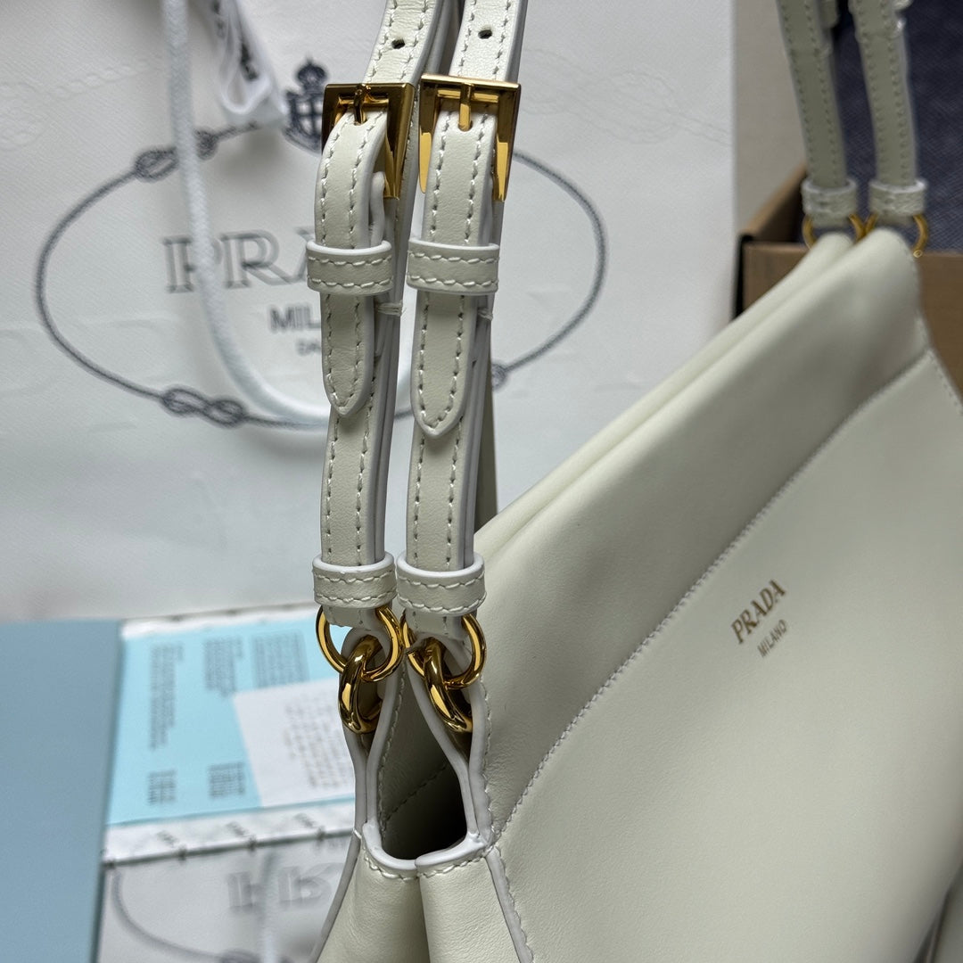 Prada white leather handbag strap ends with gold-tone clips and stitched edges