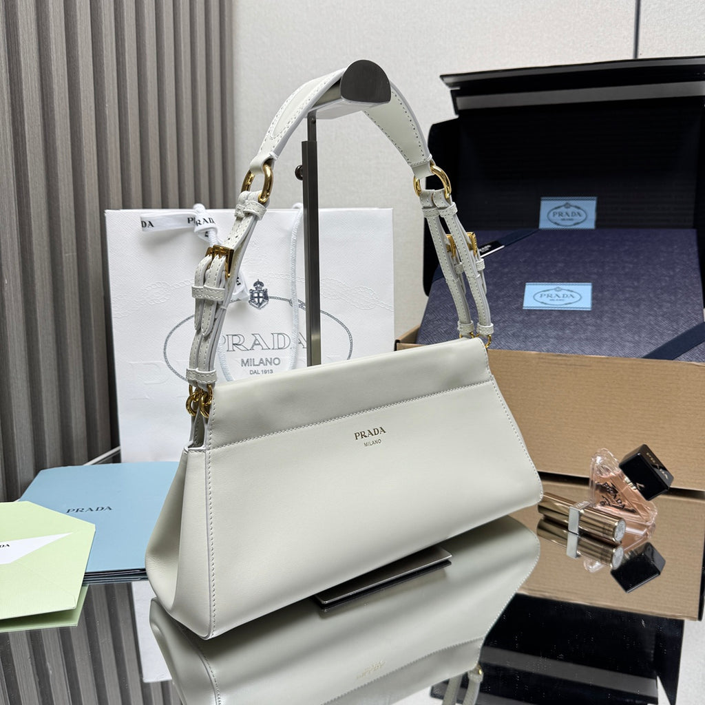 Prada white leather handbag angled view with top handle and gold-tone rings