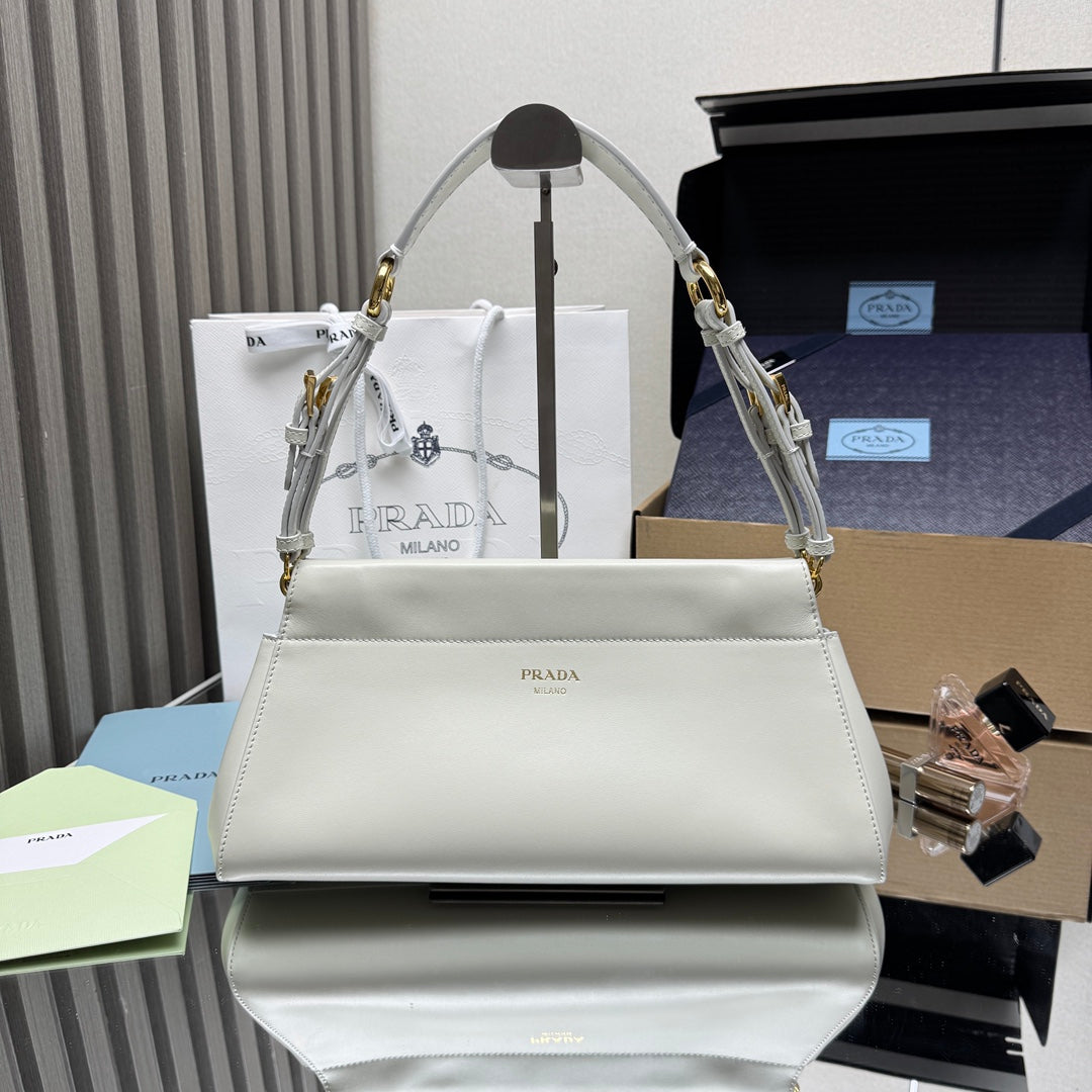 Prada white leather handbag with top handle, gold hardware, and front logo plaque