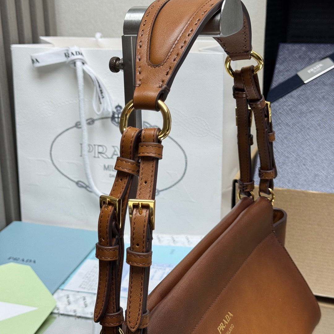 Prada brown leather top-handle bag with gold-tone buckles and chain hardware