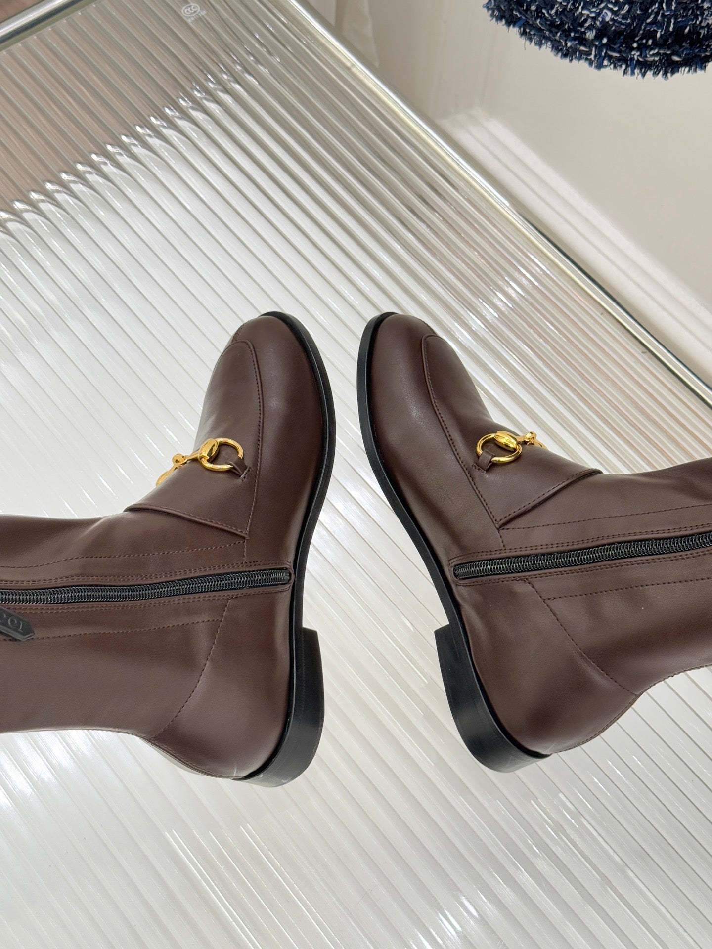 Gucci ladies knee-high leather boots, dark brown, showing slip-on profile and stitch seams