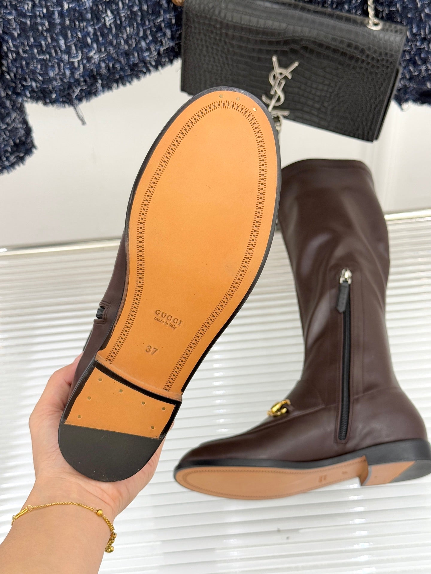 Gucci ladies knee-high boot sole and side view in dark brown leather with gold trim