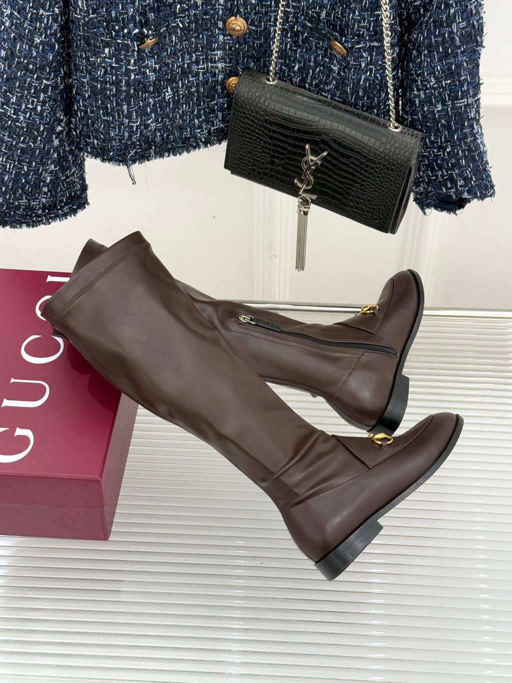 Gucci ladies knee-high leather boots, dark brown, side angle with gold stirrup detail