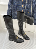 Black leather knee-high boots with gold horsebit straps and side zipper