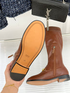 Gucci ladies knee-high leather boot showing sole and side zipper, tan/brown, gold-tone strap