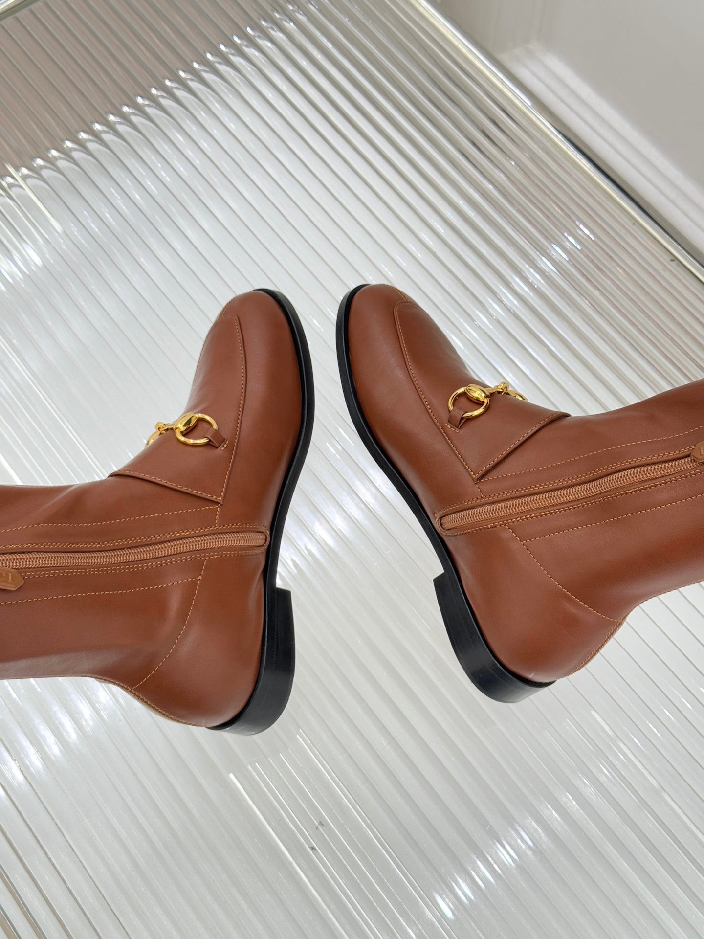 Gucci ladies knee-high leather boots viewed from top, tan/brown with gold-tone horsebit detail
