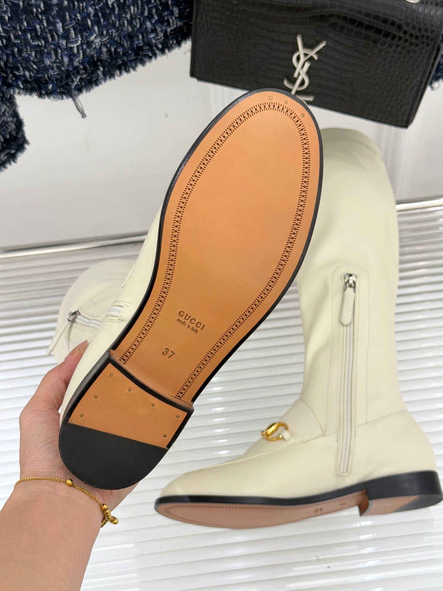 Women's off-white knee-high boots outsole, Gucci text, black heel and trim