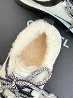 Chanel sneaker close-up with fuzzy white interior and stitched toe panel