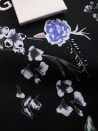 Black sweatshirt with scattered blue and purple floral embroidery detail