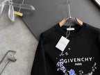 Black crewneck sweatshirt with blue floral wreath logo and white “GIVENCHY PARIS”